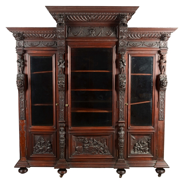 ARCHITECTURAL CARVED MAHOGANY THREE DOOR BOOKCASE.