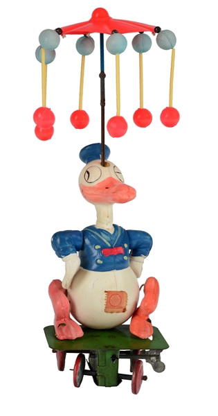 PRE-WAR JAPANESE TIN AND CELLULOID WIND UP DONALD DUCK CAROUSEL. 