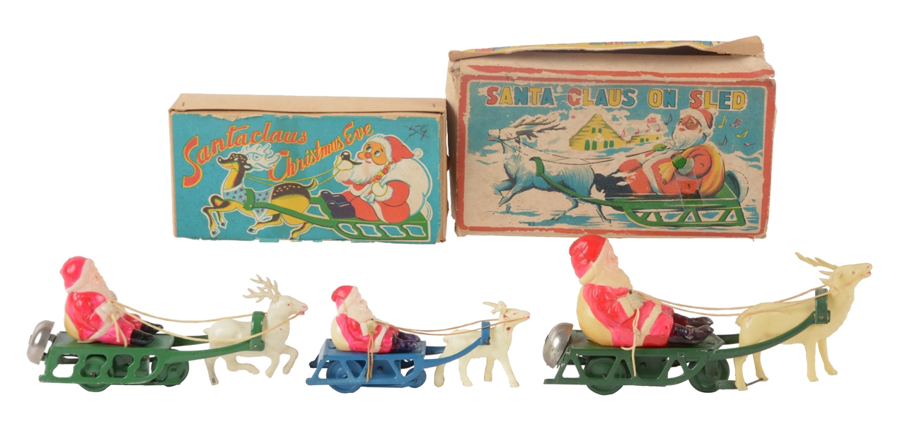 LOT OF 3: TIN AND CELLULOID WIND UP SANTA SLEIGHS.