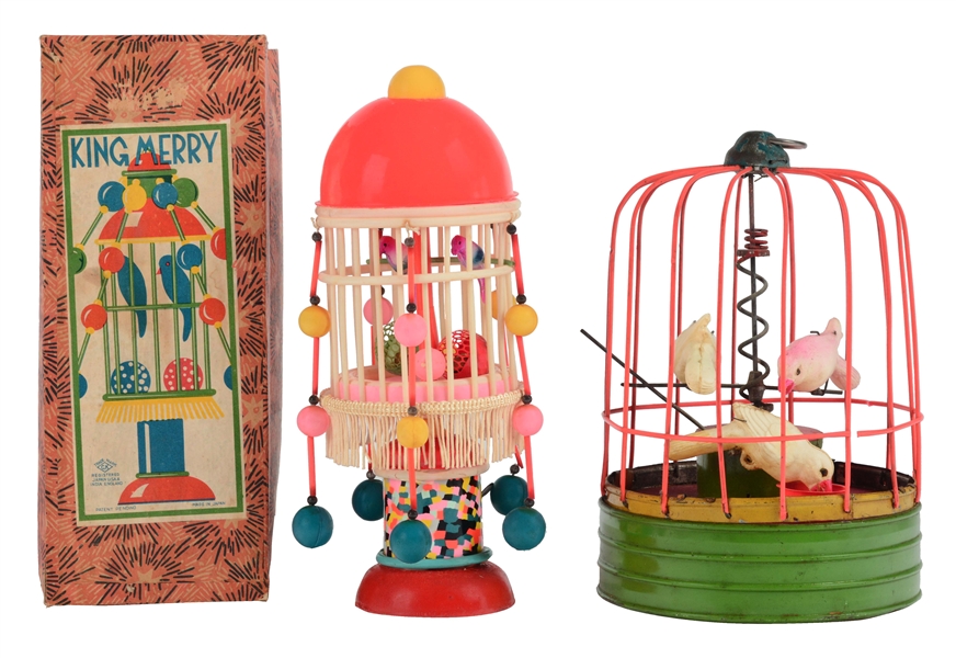 LOT OF 2: PRE-WAR JAPANESE PAINTED TIN AND CELLULOID WIND UP BIRD CAGES.