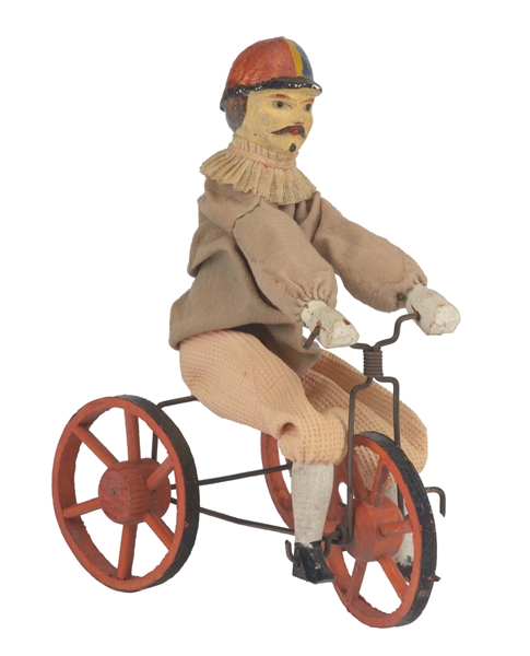 WOODEN MAN RIDING ON A TRICYCLE. 