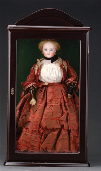 FRENCH FASHION DOLL IN WOODEN GLASS-FRONTED DISPLAY CASE.
