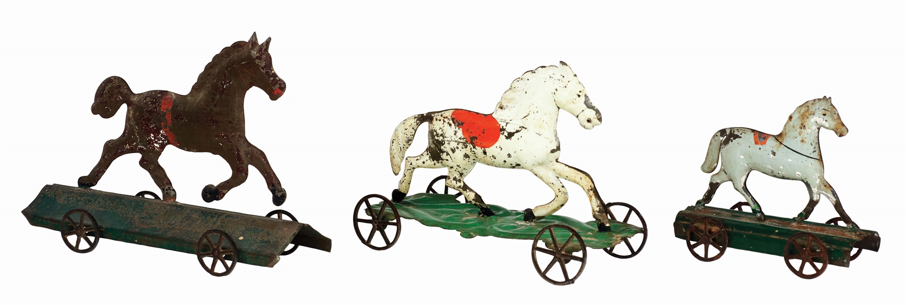 LOT OF 3: EARLY AMERICAN TIN HORSE ON PLATFORM TOYS.
