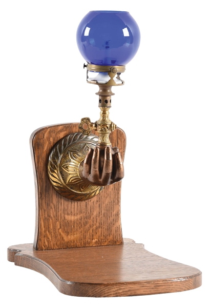UNUSUAL BALL-IN-HAND CIGAR LIGHTER WITH BLUE GLOBE.