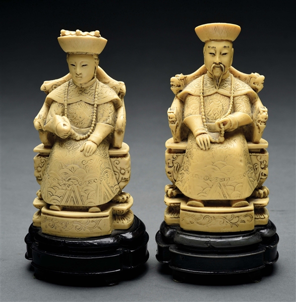 CARVED IVORY PAIR OF MAN AND WOMAN SEATED AT THRONE.