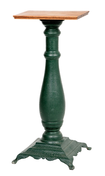 CAST-IRON SLOT MACHINE STAND IN ADDED GREEN PAINT.