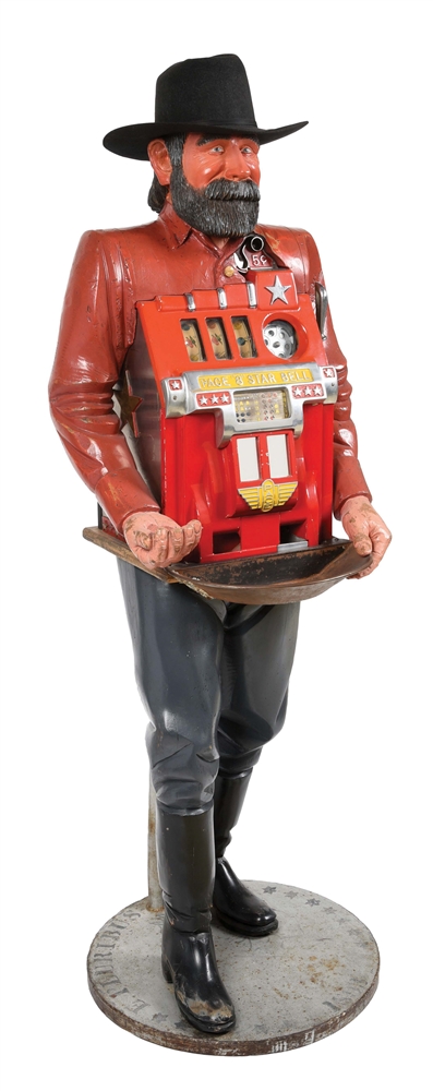 FRANK POLK CARVED PROSPECTOR SLOT MACHINE STAND FEATURING A 5¢ PACE 8 STAR BELL SLOT MACHINE.