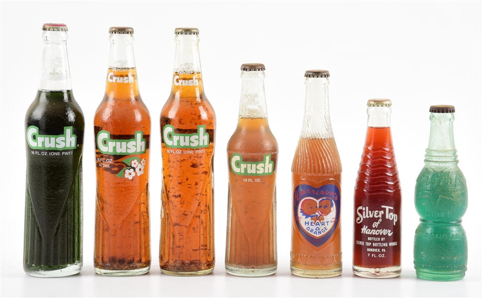 COLLECTION OF ORANGE-CRUSH AND OTHER SODA BOTTLES.
