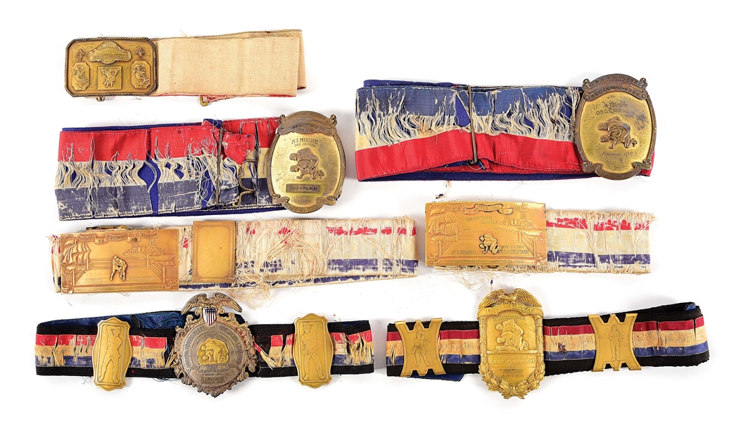 LOT OF 7: US 1920S-1930S NAMED USS CALIFORNIA HEAVYWEIGHT WRESTLING CHAMPIONSHIP BELTS.