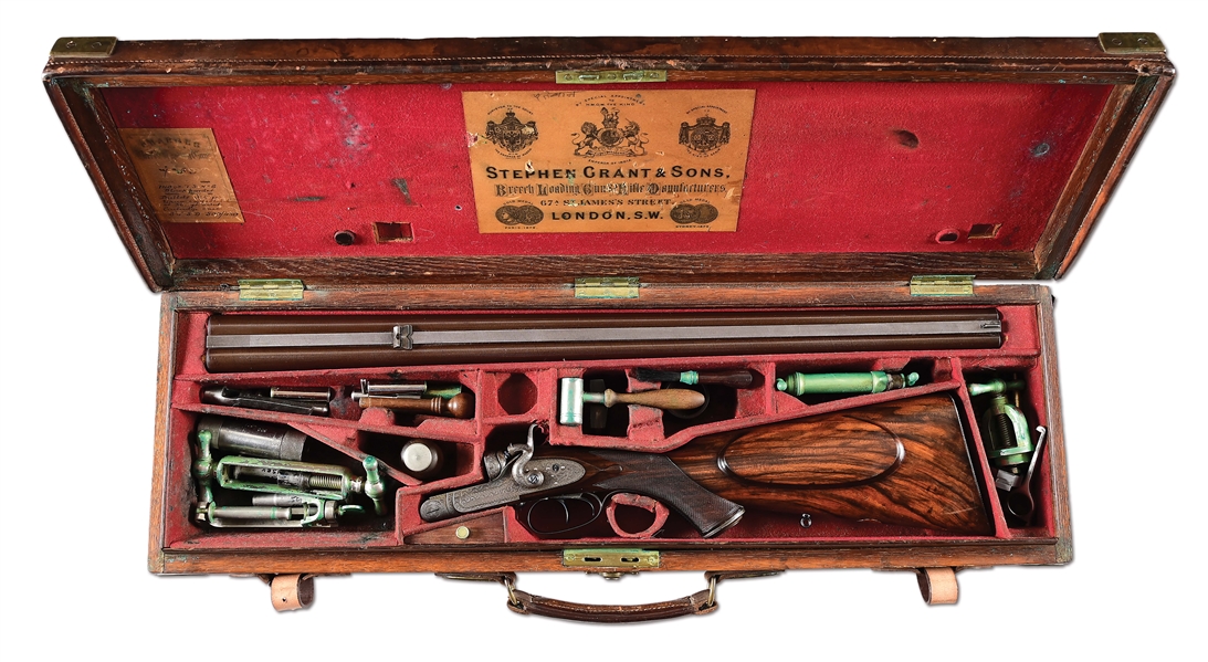 (A) AN ATTRACTIVE AND WELL ACCESSORIZED STEPHEN GRANT & SONS 450 SIDELEVER DOUBLE RIFLE WITH CASE.