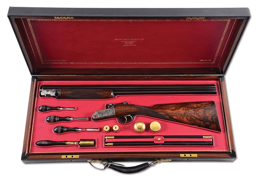 (M) DAVID MCKAY BROWN ROUND ACTION GAME GUN WITH FRENCH FITTED CASE AND ACCESSORIES.