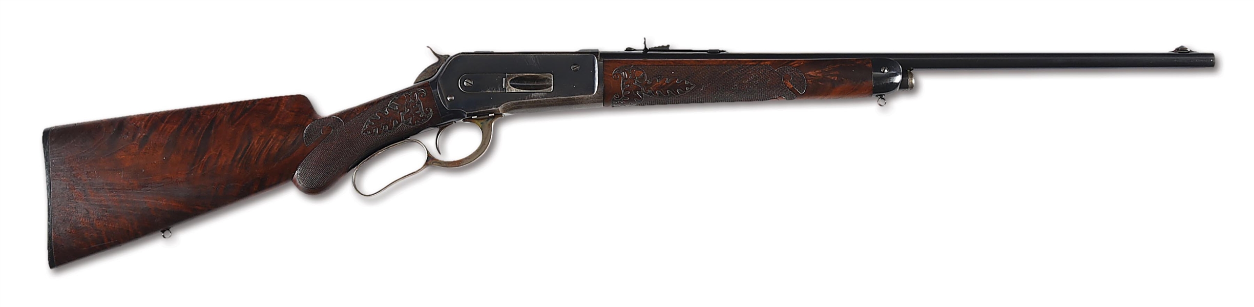 (C) RARE DELUXE WINCHESTER MODEL 1886 EXTRA LIGHT RIFLE WITH FACTORY CHEEK PIECE AND CARVED STOCKS.
