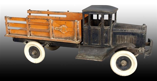 PRESSED STEEL MOTOR DRIVEN STAKE TRUCK TOY.       