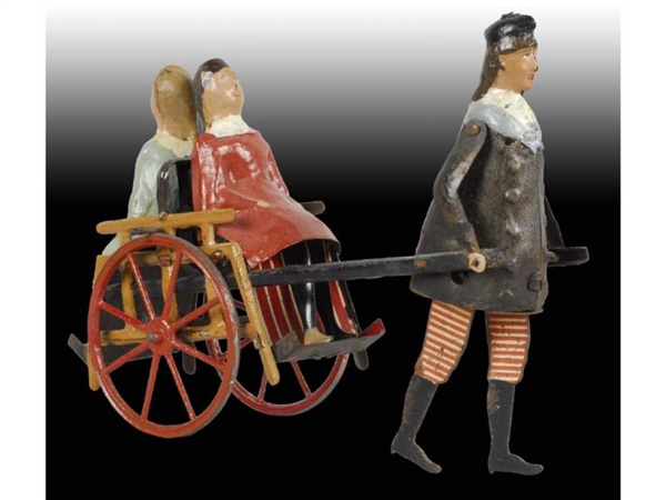 FRENCH MARTIN MAN PULLING WOMEN IN CART TOY .     