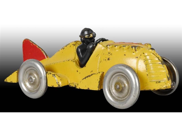 CAST IRON HUBLEY YELLOW RACER CAR TOY WITH DRIVER.