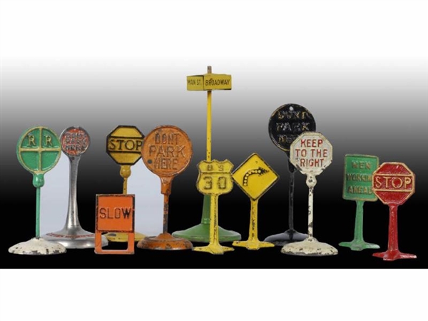 LOT OF 12: CAST IRON & TIN ROAD SIGN ACCESSORIES. 