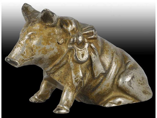 CAST IRON PIG WITH BOW STILL BANK.                