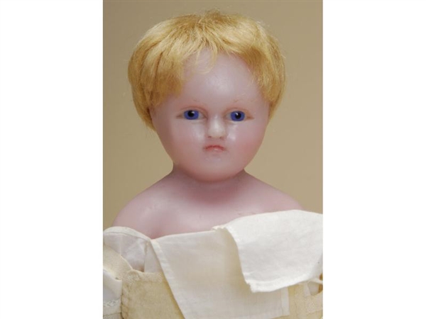 SMALL WAX CHILD WITH GLASS EYES                   