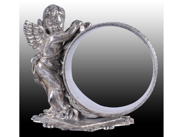 ANGEL STANDS BY FIGURAL NAPKIN RING.              
