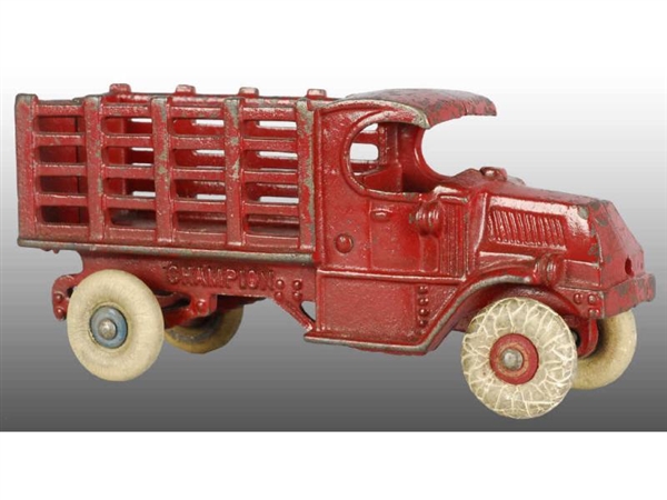 CAST IRON CHAMPION MACK RED STAKE TRUCK TOY.      