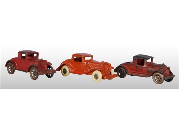 LOT OF 3: RED CAST IRON COUPE CARS.               