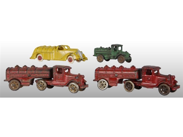 LOT OF 4: CAST IRON GASOLINE TRUCK TOYS.          