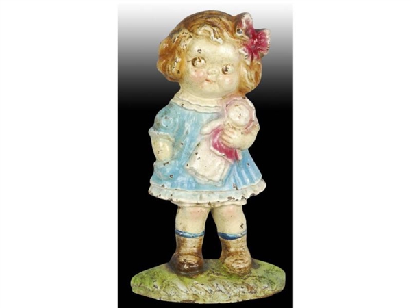 DOLLY DIMPLE HOLDING DOLL CAST IRON DOORSTOP.     