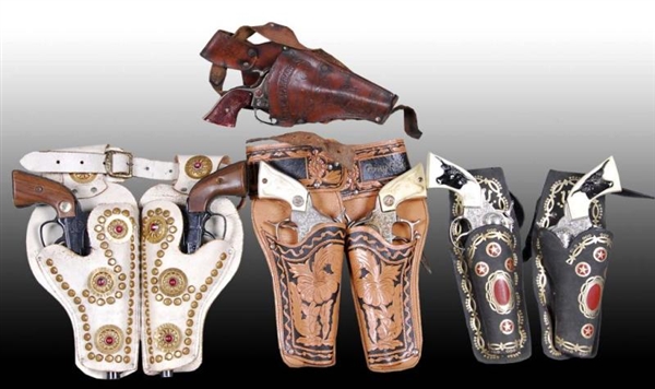 LOT OF 4: TOY HOLSTER SETS WITH GUNS.             