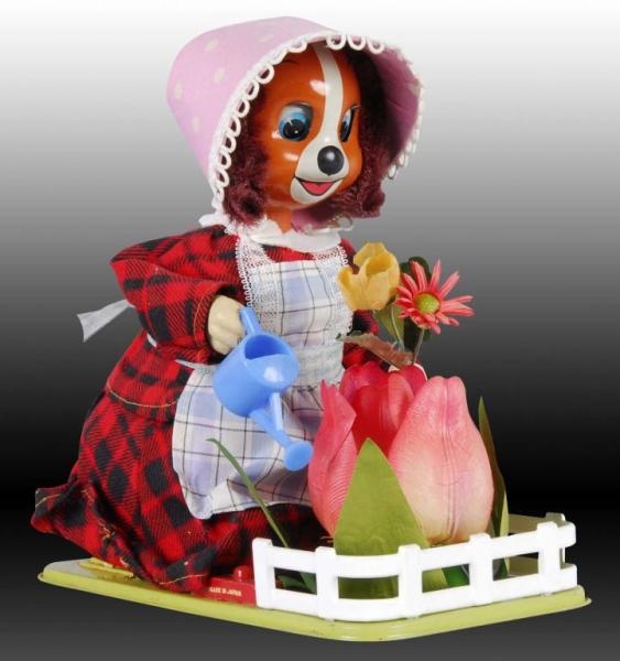 BATTERY-OPERATED LADY PUP TENDING HER GARDEN TOY. 