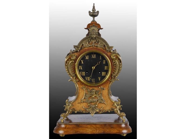 BRASS AND WOOD FRENCH CLOCK.                      