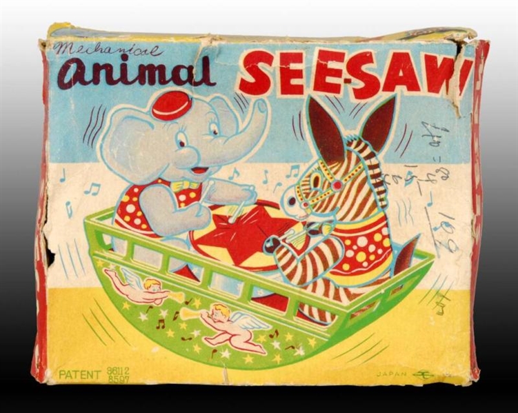 JAPANESE TIN WIND-UP ANIMAL SEE-SAW TOY.          