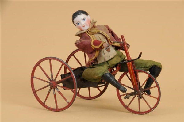 EARLY MECHANICAL BOY ON VELOCIPEDE                