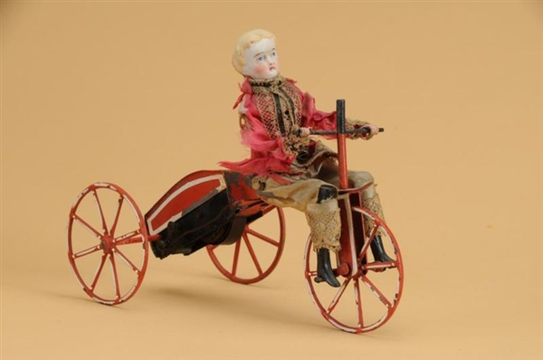 EARLY MECHANICAL BOY ON VELOCIPEDE                