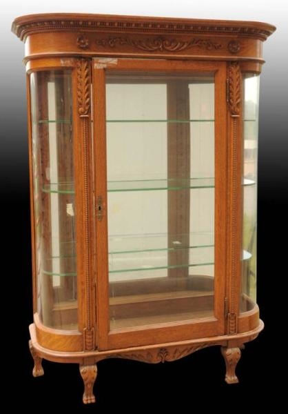 OAK DISPLAY CASE WITH CURVED GLASS SIDES.         