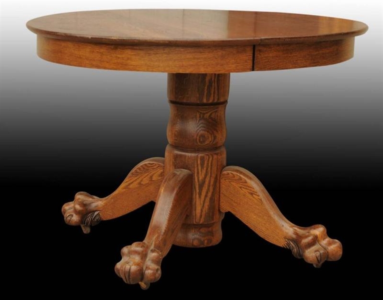OAK ROUND TABLE WITH CLAW FEET.                   