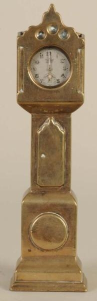 BRASS WATCH HUTCH IN THE FORM OF A TALL CLOCK.    