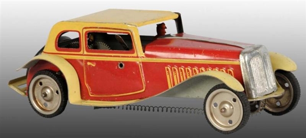 TIN AUTOMOBILE WIND-UP TOY.                       