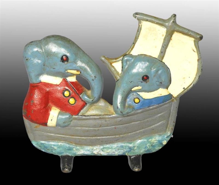 CAST IRON BABAR AND ARTHUR IN A BOAT DOORSTOP.    