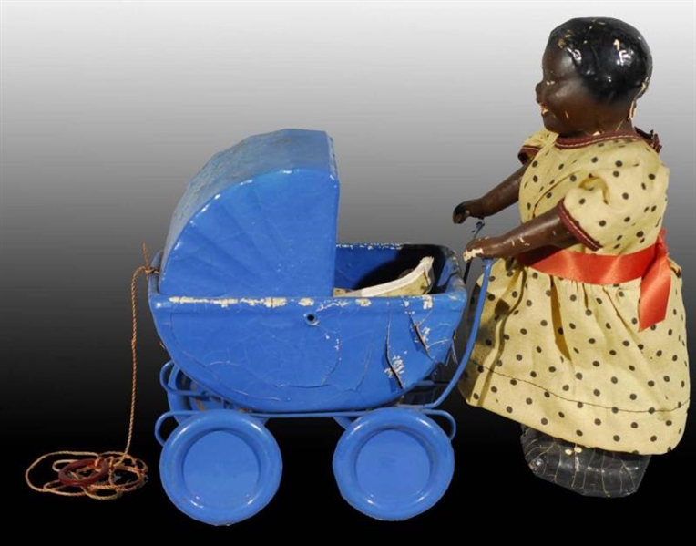 WOMAN PUSHING DOLL CARRIAGE PUSH TOY.             