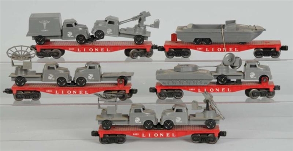 LOT OF 5: LIONEL FLAT CARS WITH MILITARY VEHICLES.
