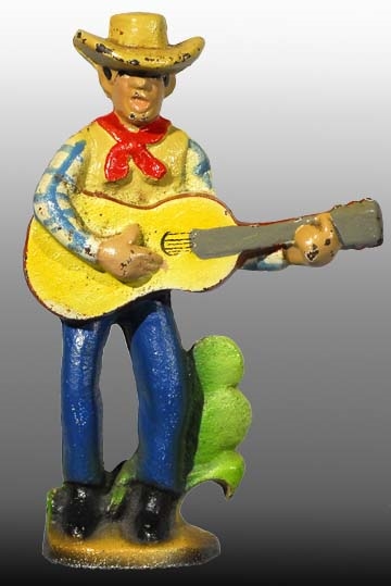 CAST IRON COWBOY WITH GUITAR BOTTLE OPENER.       