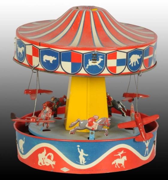 TIN WOLVERINE LEVER ACTIVATED MERRY-GO-ROUND TOY. 