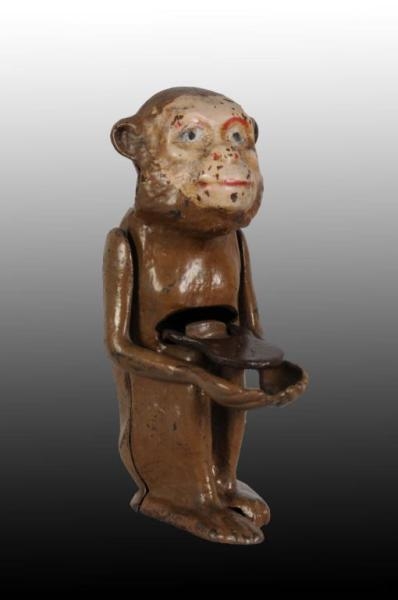 CAST IRON MONKEY WITH TRAY  MECHANICAL BANK.      