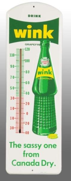 EMBOSSED TIN WINK BY CANADA DRY THERMOMETER.      