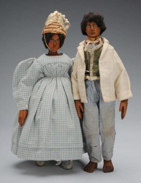 PAIR OF WOOD JOINTED CHARACTER DOLLS.             