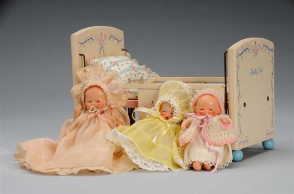 LOT OF 3: PAINTED BISQUE BABIES WITH A DOLLY CRIB.