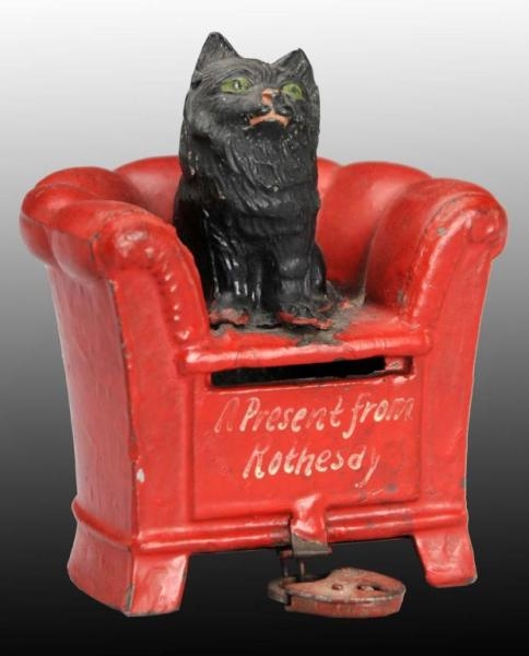 LEAD BLACK CAT ON RED CHAIR STILL BANK.           