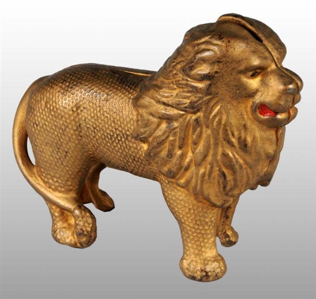 CAST IRON QUILTED LION STILL BANK.                