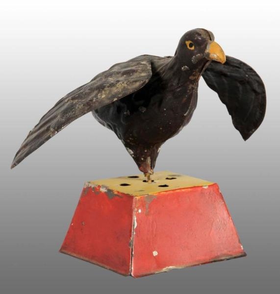TIN HAND-PAINTED HAWK WIND-UP TOY ON BASE.        
