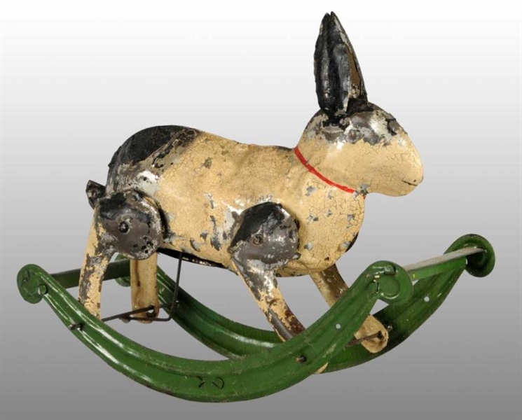 TIN HAND-PAINTED RABBIT ON ROCKER WIND-UP TOY.    